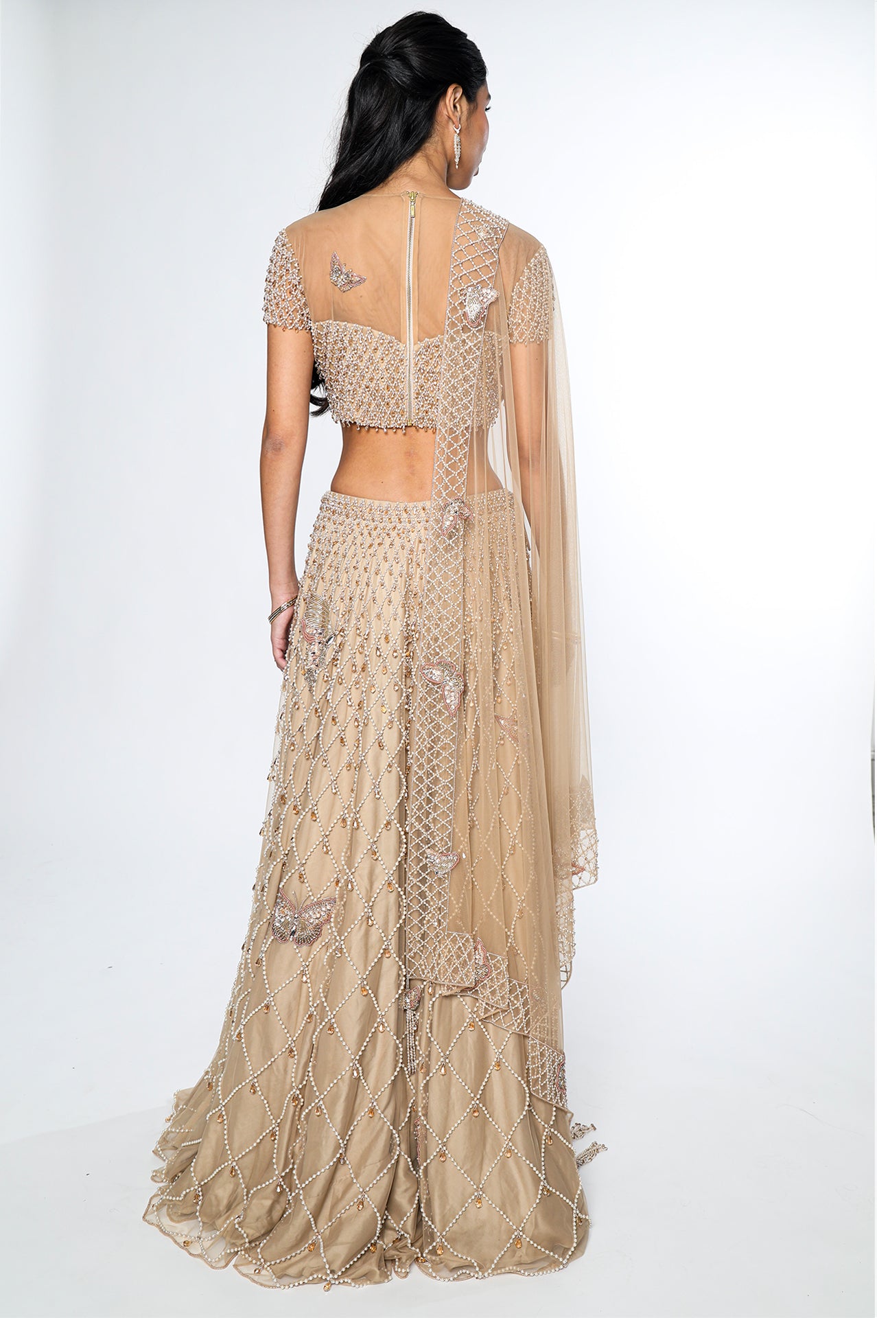 Beige embroidered traditional outfit on a white background